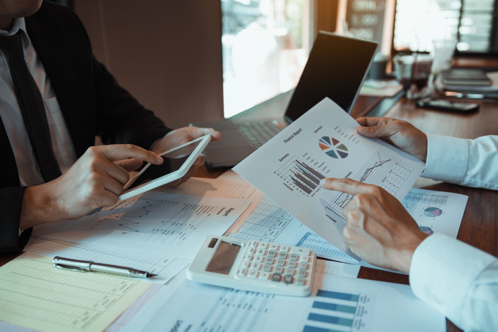 Business partnership coworkers using a tablet to analysis graph